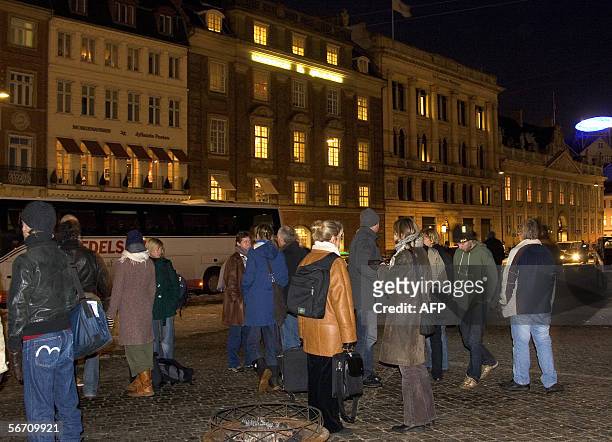 Employees of the Danish newspaper Jyllands-Posten stand in front of the paper's building in Copenhagen 31 January 2006. The offices of Danish...