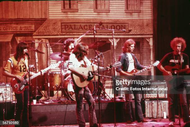 American soft-rock ensemble The Eagles perform on stage before a faux Old West backdrop, 1974. Members of the band are bassist Randy Meisner, drummer...