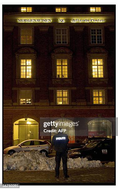 Police officer stands in front of the Danish newspaper Jyllands-Posten's building in Copenhagen, 31 January 2006. The building as well as the paper's...