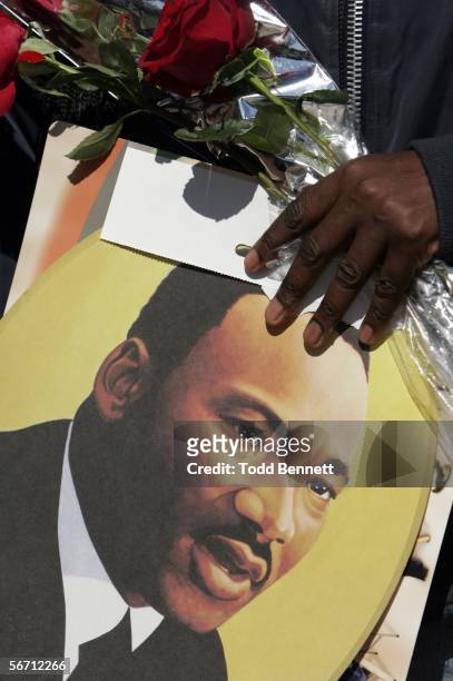 Visitor to the King Center holds a picture of Dr. Martin Luther King Jr. And flowers following the death of his widow Coretta Scott King January 31,...