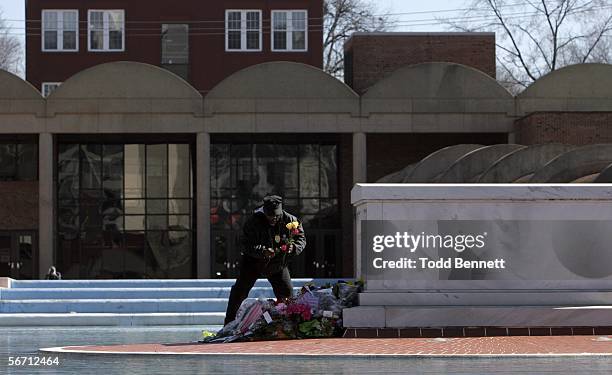 King Center employee, Sgt. Richart Cheatham, places flowers at the base of Dr. Martin Luther King Jr.'s tomb, following news of the death of King's...