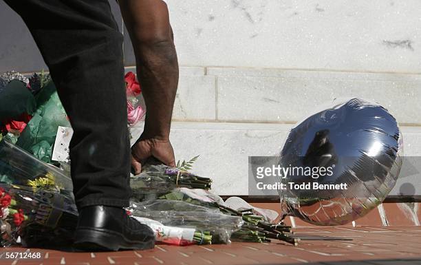 King Center employee, Sgt. Richart Cheatham, places flowers at the base of Dr. Martin Luther King Jr.'s tomb, following news of the death of King's...