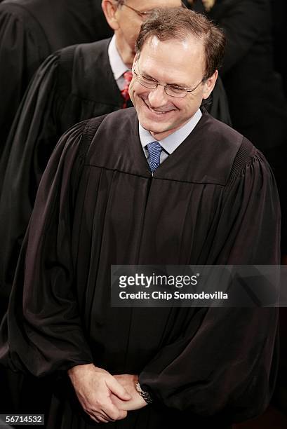 Newly sworn-in Supreme Court Associate Justice Samuel Alito reacts as he is applauded after U.S. President George W. Bush mentioned his confirmation...