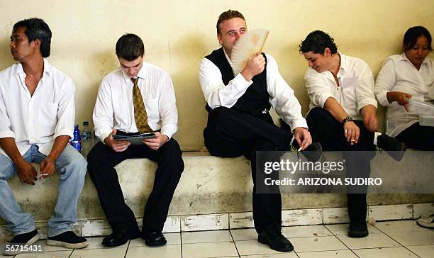 Australian Scott Rush , Martin Stephens and Renae Lawrence with unidentified others wait in a district court's cell before their trial to deliver...