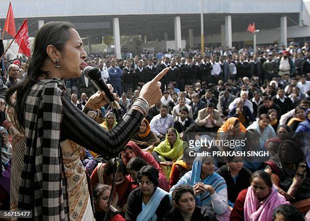 Leader of India's CPI Brinda Karat gestures as she addresses a gathering of Airport Authority employees during a sit-in-protest at Indira Gandhi...