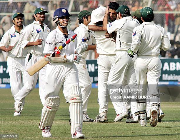 Pakistani bowler Abdul Razzaq celebrates with his teammates after taking the wicket of Indian cricketer Sourav Ganguly for 37 runs during the fourth...