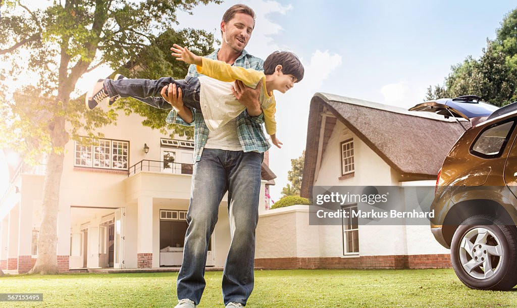 Father and son play airplane