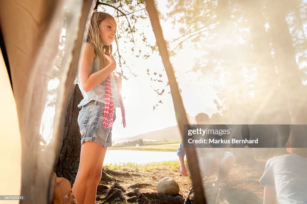 Girl stand outside of tent