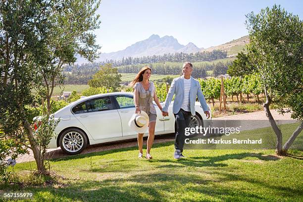 confident couple arriving at their estate - holding hands in car stock pictures, royalty-free photos & images