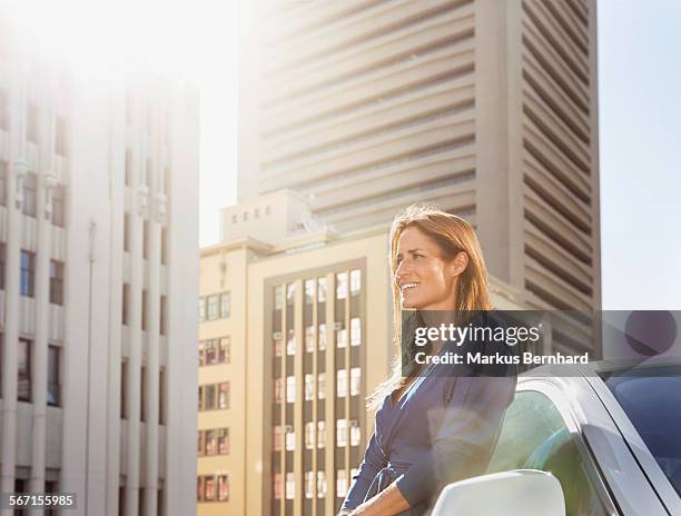 woman waiting at her car - modern maturity center foto e immagini stock