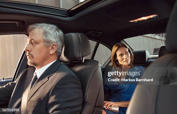 chauffeur is driving mature woman. - chauffeur 個照片及圖片檔