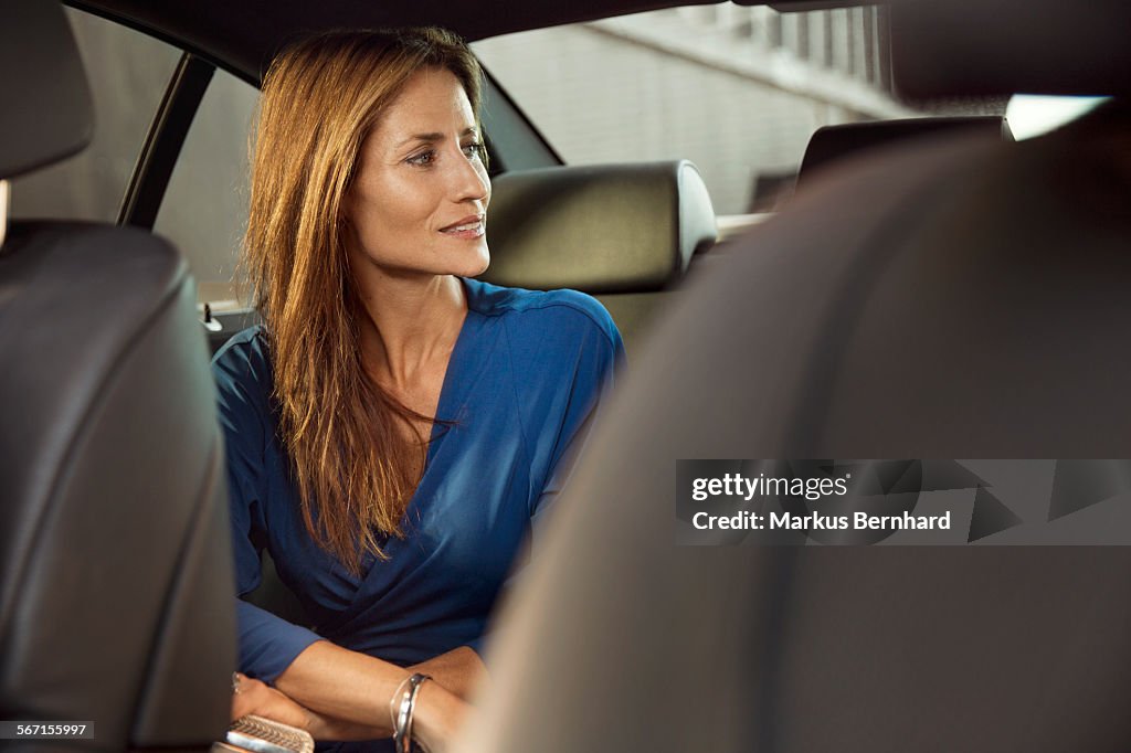 Confident woman sitting in car
