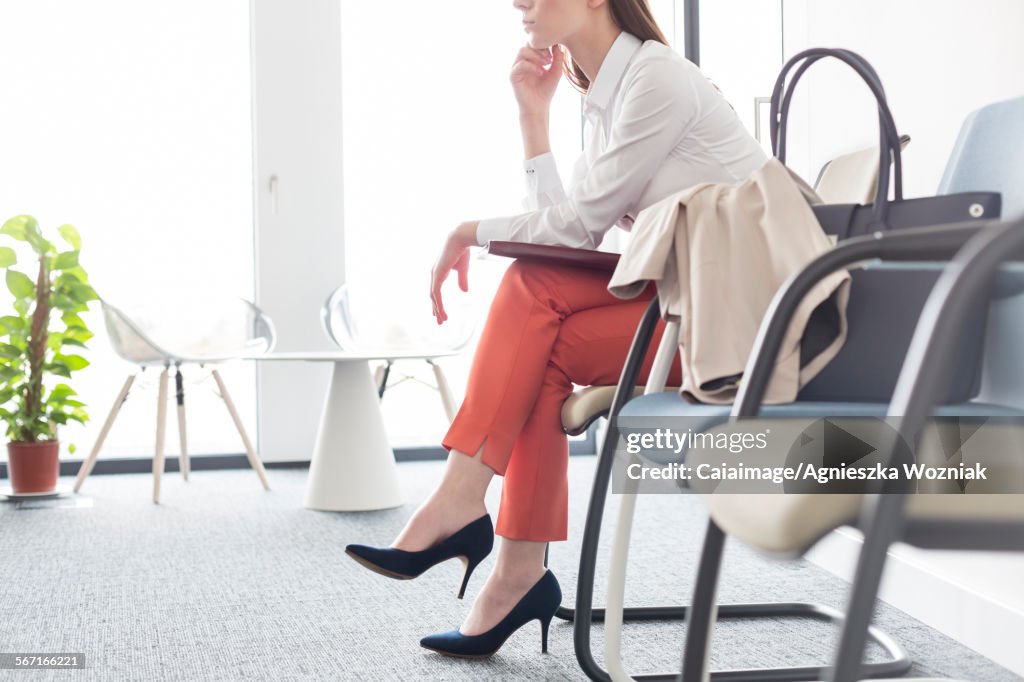 Businesswoman waiting with legs crossed in lobby