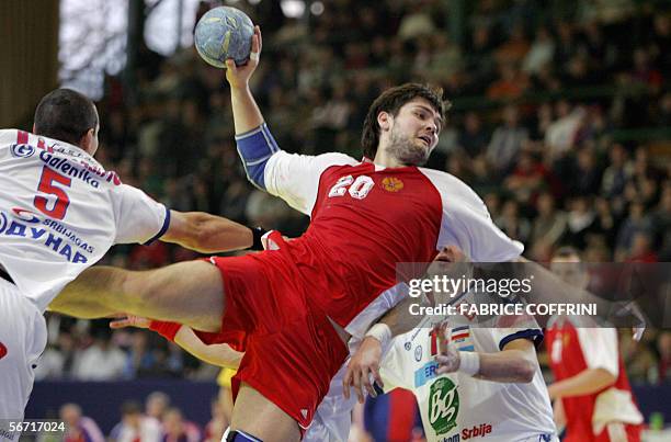 Russia's Mikhail Chipurin scores between Serbia and Montenegro's Marko Krivokapi and compatriot Alem Toskic, during their game at the main round of...