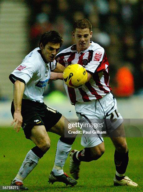Marc Edworthy of Derby County battles for the ball with Chris Armstrong of Sheffield United during the Coca-Cola Championship match between Derby...