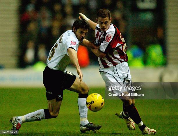 Marc Edworthy of Derby County battles for the ball with Chris Armstrong of Sheffield United during the Coca-Cola Championship match between Derby...