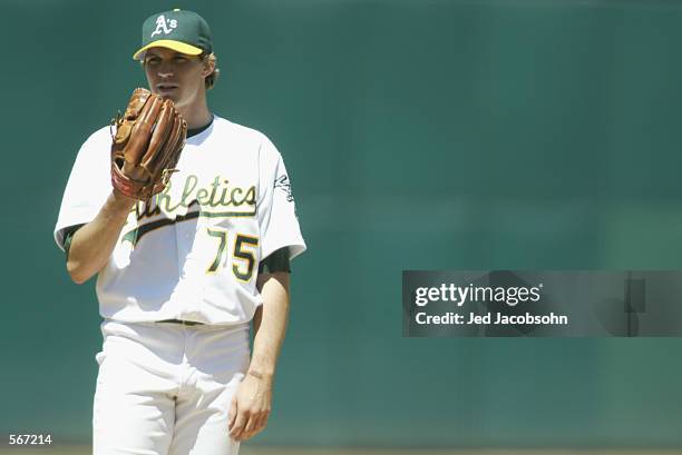 Pitcher Barry Zito of the Oakland A's looks in for the sign against the Toronto Blue Jays during the MLB game at Network Associates Coliseum in...