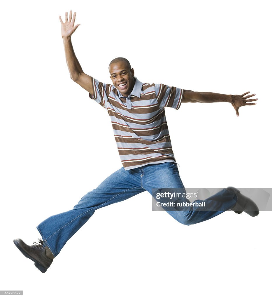 Portrait of a young man jumping in mid-air