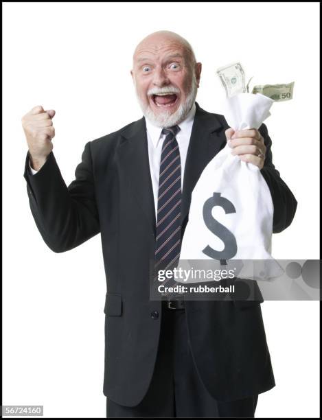 portrait of a businessman holding dollar bills in a bag - dollar face photos et images de collection