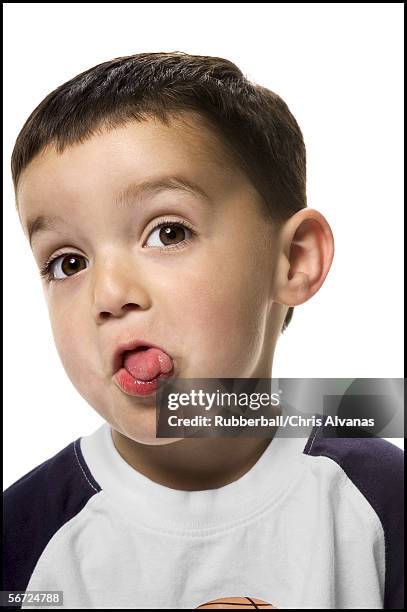 close-up of a boy sticking out his tongue - ugly boys fotos stock-fotos und bilder