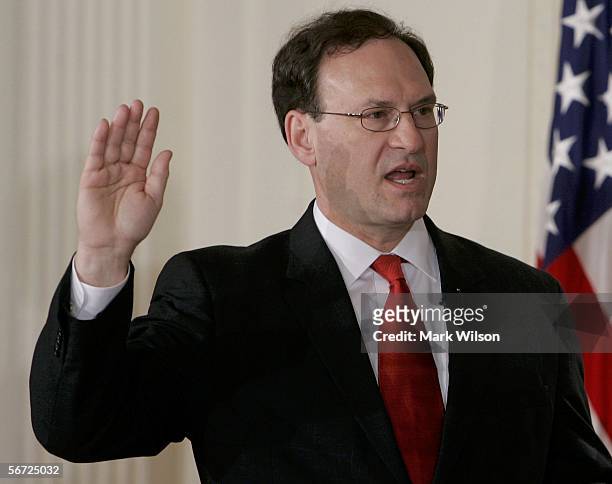 Samuel Alito raises his right hand as he is sworn in as Associate Justice of the United States Supreme Court during a ceremony in the East Room at...