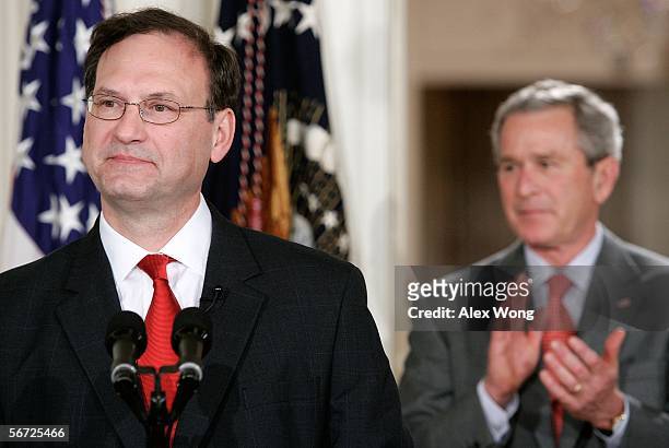 President George W. Bush applauds as Justice Samuel Alito makes his remarks during a ceremonial swearing-in at the East Room of the White House...