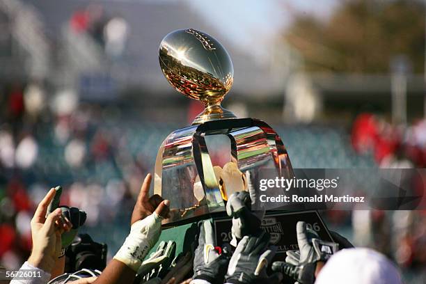 Alabama Crimson Tide players hold the championship trophy following the game against the Texas Tech Red Raiders during the AT&T Cotton Bowl on...