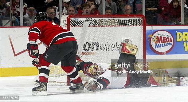 Dominik Hasek of the Ottawa Senators makes a sprawling save on Brian Gionta of the New Jersey Devils at the Continental Airlines Arena on February 1,...