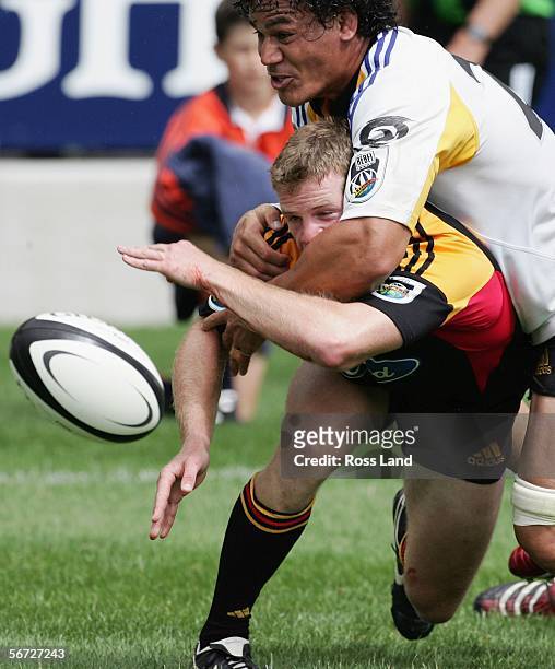 Jamie Nutbrown of the Chiefs is tackled by Chris Masoe of the Chiefs during the Super 14 rugby pre-season match between the Hurricanes and the Chiefs...