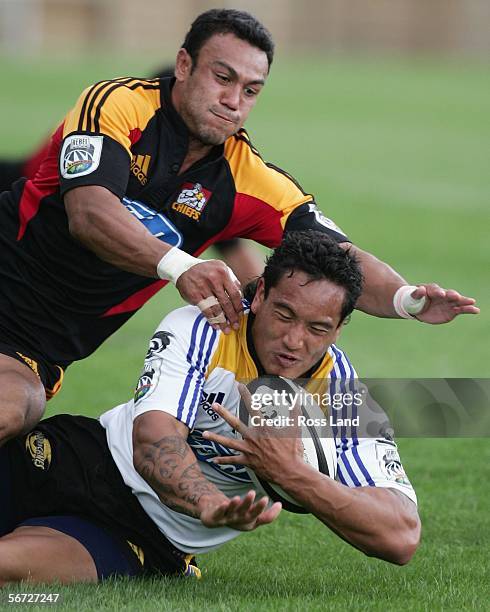 Hosea Gear of the Hurricanes tackled by Stephen Setephano of the Chiefs during the Super 14 rugby pre-season match between the Hurricanes and the...