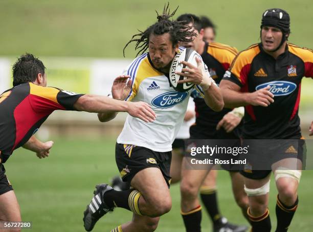 Former All Black captain Tana Umag of the Hurricanes breaks through the defence during the Super 14 rugby pre-season match between the Hurricanes and...