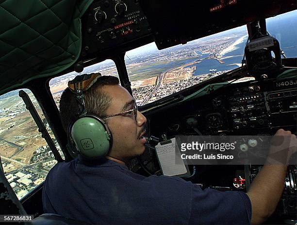 Airline.7.LS. Capt. Jose Diaz pilots DC3 cargo plane of Catalina Flying Boats on return trip to Long Beach after ferrying supplies to Santa Catalina...