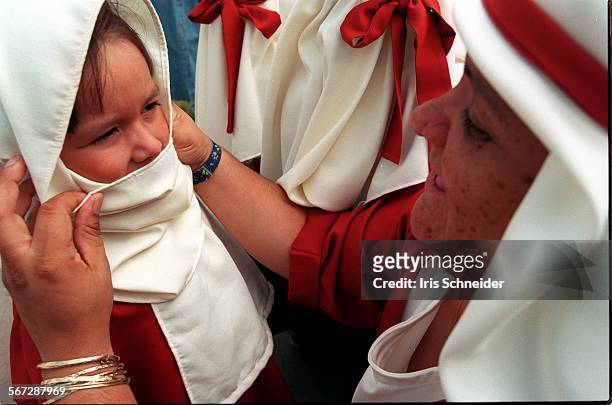 Headstart.3.0522.IS.Teacher Elisa Mir from a Headstart site in Southgate adjusts scarf of Pearl Oliva before they march in the 5th Annual...