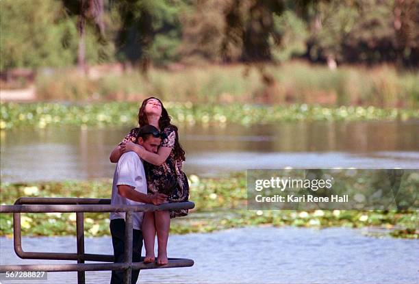 WildArt.rays1.KH.10/3/95.Maria Ruiz of Fullerton catches the warmth of the afternoon sun on her face while holding David Seminario of Fullerton at...