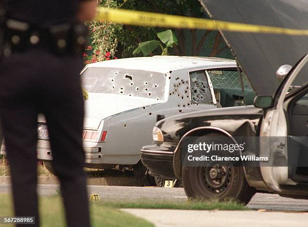 Shooting#1a.0625.CW After the chase and a shootout the suspect's bullet riddled car came to a stop at the corner of 130th and Compton. One man died...