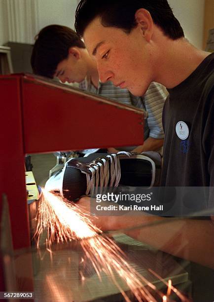 Ice.sharpen4.KH.9/1/95.Brent Stelzer of Ontario and Calvin Rouw of Walnut, both of operations/skate guard, sharpen hockey skates in preparation for...