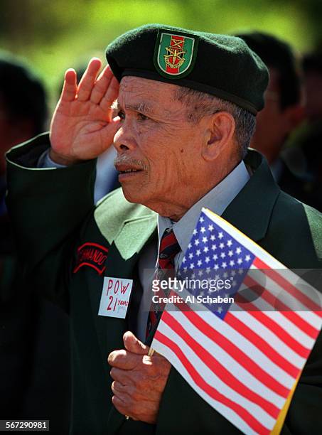 South Vietnamese Commando Chap Ha of Santa Ana, a prisoner of war for 21 years, salutes as the National Anthem of South Vietnam is sung Sunday during...