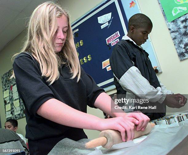 Holiday.roll.D.112498.KRHDiane Reno, 12 rolls out plastic molding dough while Edward Varnie uses a cookie cutter to cut out the ornaments during a...