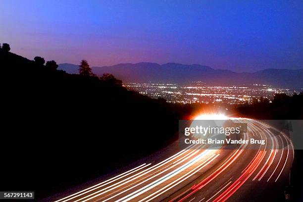 Looking northbound along the 405 freeway in the Sepulveda Pass, a view of the lights of the San Fernando Valley opens up from the bridge at...