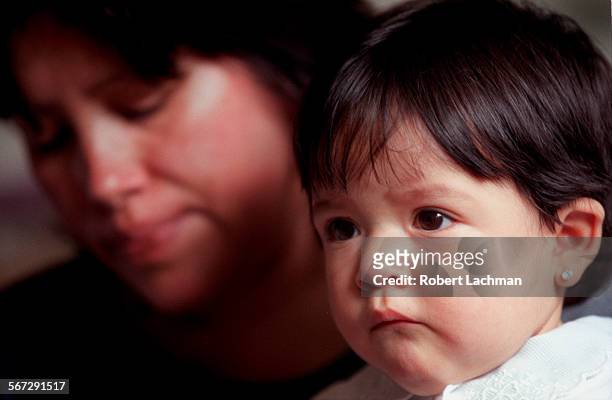 Sarabia.tight.0423.RDL Tiffany Sarabia, 11 months and her mother Teresa Sarabia. Tiffany nearly died when she slipped out of her mother's arms during...