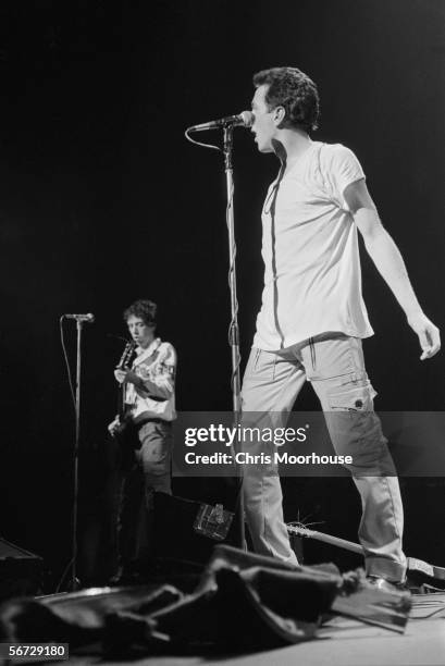 British singer Joe Strummer and guitarist Mick Jones of punk band The Clash on stage at the Rainbow Theatre, London during their 'White Riot' tour,...