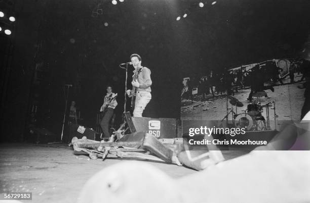 British singer Joe Strummer with guitarist Mick Jones and drummer Topper Headon of punk band The Clash on stage at the Rainbow Theatre, London during...