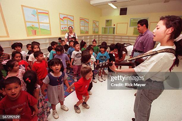 Ninos.2.0421 Susan Han leads preschoolers in a song during dedication ceremony rehearsal for the new S. Mark Taper Foundation Child Care Wing...