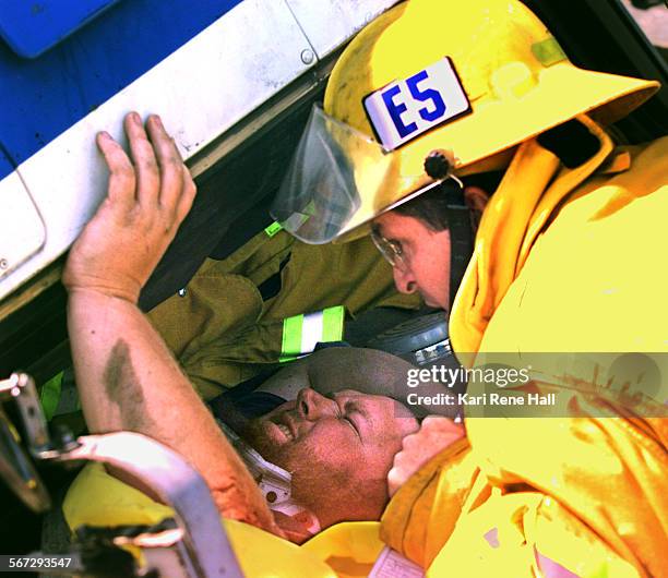 Overturn.comfort2.KH.3/12/97.Anaheim Fire Department paramedic Randy Bayless tries to comfort Gary Pearson of San Bernardino as a tow truck lifts the...