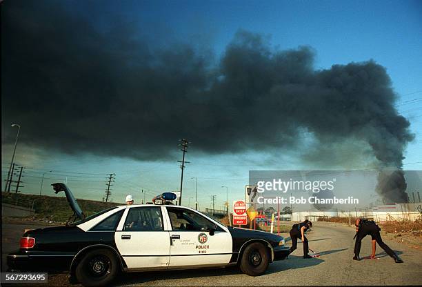 Texaco#1.1111.BC/A.Two Los Angeles Police oficers block off onramp leading to Pacific Coast Highway as Texaco refinery fire billows hundreds of feet...