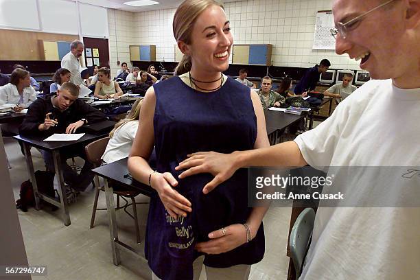 Erik Jarrin age 17 touches the empathy belly on Crystal Wilkinson age 17 which simulates a pregnancy at 8 months. They are in science class at Simi...