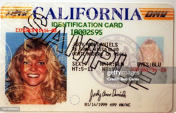 This is an example of the DMV's most recent style for driver's licenses and identification cards, with a light photo of the subject imprinted on the...