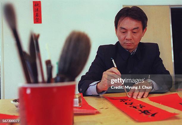 The Rev. Johnny Chan writes out greetings in calligraphy to celebrate the Chinese New Year which will be on Saturday. The greetings will hang on the...