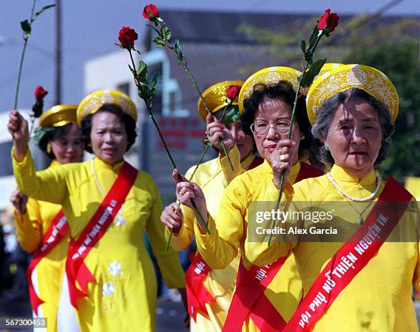 Tetparade.women.0220.AAGHolding roses high, members of the Trieu Lady of Southern California Women Association Charity participate in the Tet...