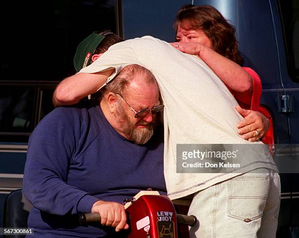 Fire.consoled.0108.DK.Lewis Silvers, left, grief stricken Father and Grandfather to victims of this morning tragic fire in Orange, is consoled by...